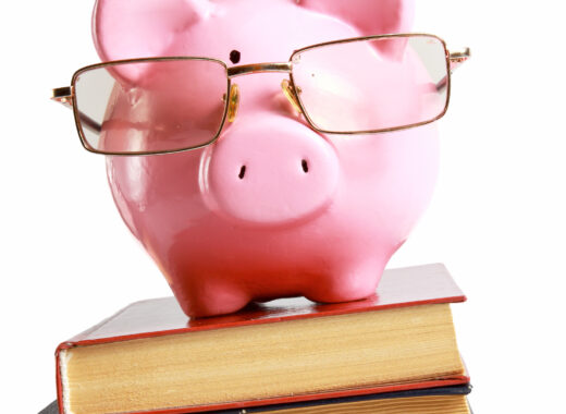 piggy bank with glasses and book isolated white background