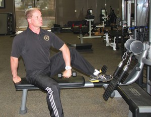Trainer Mike Butler demonstrates weight bearing exercises to strengthen shoulder muscles and avoid rotator cuff injuries