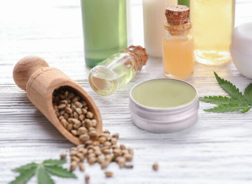 Beautiful composition with jar of hemp lotion on wooden background